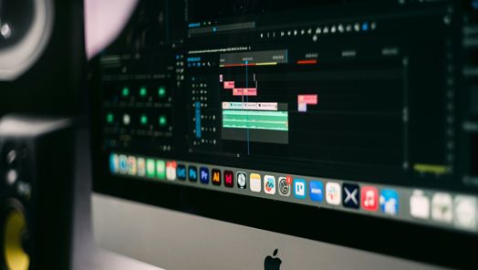 Image of a MacBook computer open to a page of editing software.