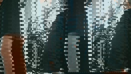 Two people stand looking at a large cinema camera