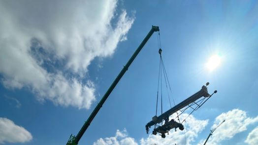 A large crane operates on a construction site