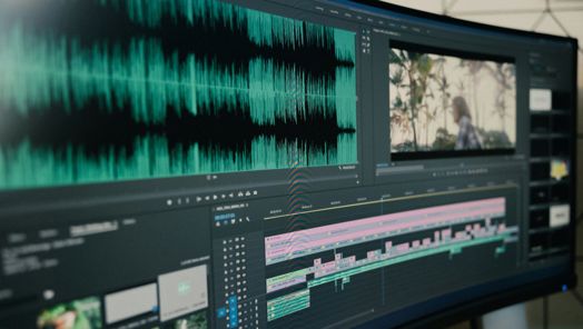 A large computer monitor open to audio tracks within a video editing software.