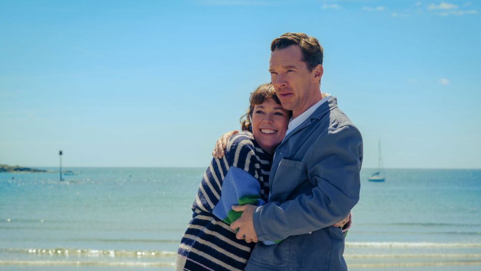 Olivia Colman and Benedict Cumberbatch embracing on a beach
