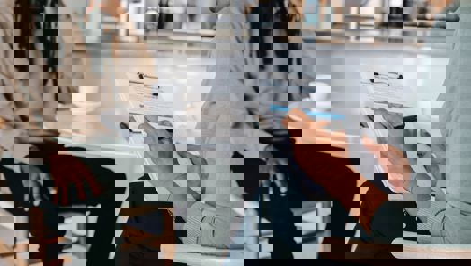 office worker taking notes during a meeting