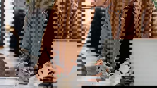 assistant taking notes on a notebook