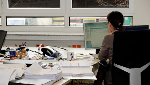 assistant sitting by an office desk