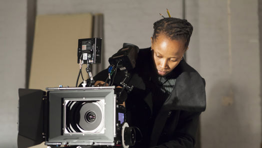 Young woman behind a camera